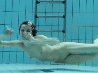 Podvodkova swimming in blue bikini in the pool