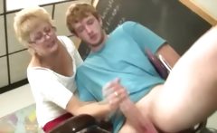 Granny Teacher Tugs Her Students Cock In The Classroom