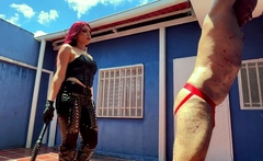 Leather mistress whips her slave with her bullwhip